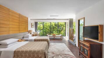 A hotel room with two beds, a large window, a TV, and a wooden cabinet.