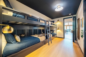 A bunk bed room with a ladder, a desk, and a chair. - Lakeview A-Frame with hot tub near RMNP (Grand Lake)