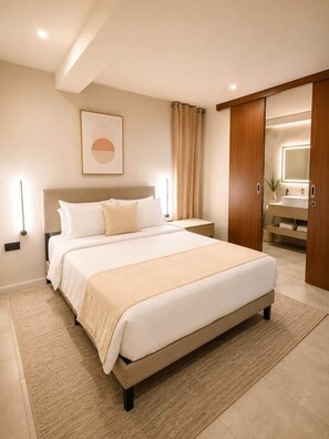 A modern bedroom with a large bed, a bedside table, a nightstand, a wall-mounted light, and a bathroom visible through an open door.