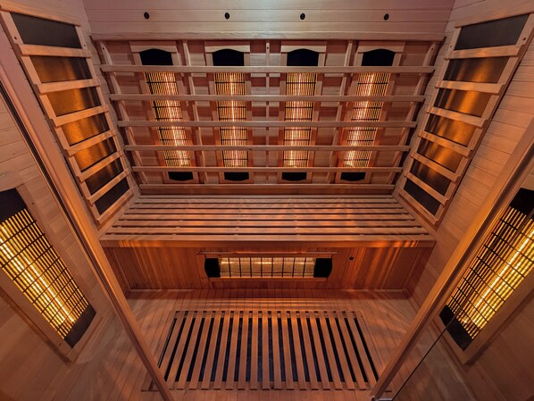 A multi-level wooden interior with slatted ceilings and a central open space.