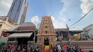 A temple with intricate architecture, surrounded by urban buildings and a busy street. - Prime Silom (Bangkok)