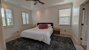 A bedroom with a bed, a nightstand, a ceiling fan, and a window with blinds. - Upper River Cottage - Main Floor & Upstairs, 3-beds, near SF River trail & parks (Spanish Fork)