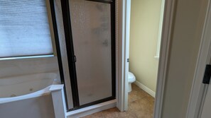 A bathroom with a bathtub, a shower enclosure, and a toilet. - Upper River Cottage - Main Floor & Upstairs, 3-beds, near SF River trail & parks (Spanish Fork)