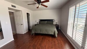 A bedroom with a bed, ceiling fan, and window blinds. - El Paso | Large Group + RV Parking (El Paso)