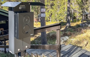 A weather station with a digital display, a QR code, and a brand name 'MONTA'.