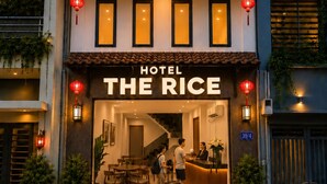 A hotel named 'Hotel The Rice' with a modern facade, a reception area, and a staircase leading to the upper floors. - The Rice Hotel&Tour - 39 Nguyen Trai No4 (Ho Chi Minh City)