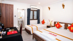 A hotel room with two beds, a desk, a chair, a sink, and a mirror. - The Rice Hotel&Tour - 39 Nguyen Trai No4 (Ho Chi Minh City)