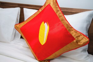 A bed with white bedding and a single red pillow with a gold trim. - The Rice Hotel&Tour - 39 Nguyen Trai No4 (Ho Chi Minh City)