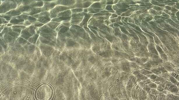 Clear shallow water with visible sand patterns. - "Sunshine, Peace & Tranquility" (Negril)