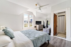 A bedroom with a bed, a television, a ceiling fan, and a view of the outside. - Steps to Beach & Boardwalk, Cozy Room, Fast WiFi, Private Bath, Coffee+Snacks #4 (Santa Cruz)