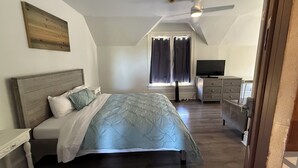 A bedroom with a bed, a dresser, a television, and a ceiling fan. - Steps to Beach & Boardwalk, Cozy Room, Fast WiFi, Private Bath, Coffee+Snacks #4 (Santa Cruz)
