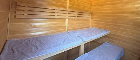 A sauna with wooden walls and benches.