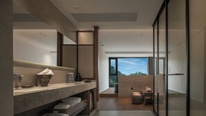A modern bathroom with a large mirror, a marble countertop, and a view of the outdoors. - Zhangjiajie national park Oxgen Resort (Zhangjiajie)