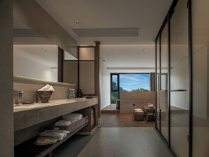 A modern bathroom with a large mirror, a marble countertop, and a view of the outdoors. - Zhangjiajie national park Oxgen Resort (Zhangjiajie)