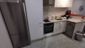 A modern kitchen with stainless steel appliances, white cabinetry, and a tiled backsplash. - *Quiet, Cozy & Family-Friendly | Pool, Gym, Shops & Transport Nearby (Northshore)