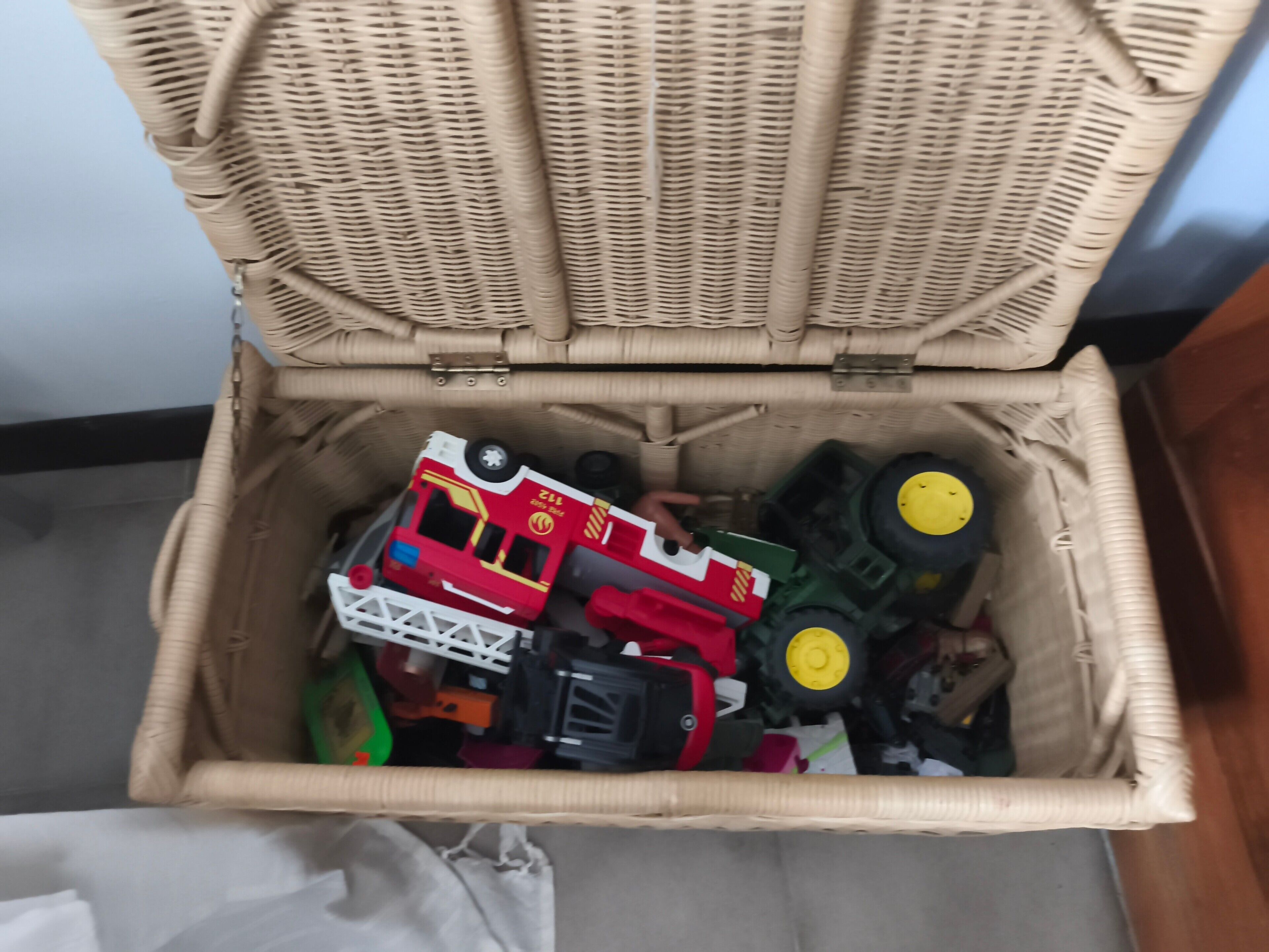 A wicker basket filled with various toys and items.
