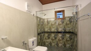 A bathroom with a glass-enclosed shower, a toilet, and a sink. - Silver Palm Resort (Anuradhapura)
