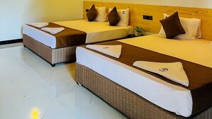 A hotel room with two beds, wooden ceiling, and wall-mounted lights. - Silver Palm Resort (Anuradhapura)