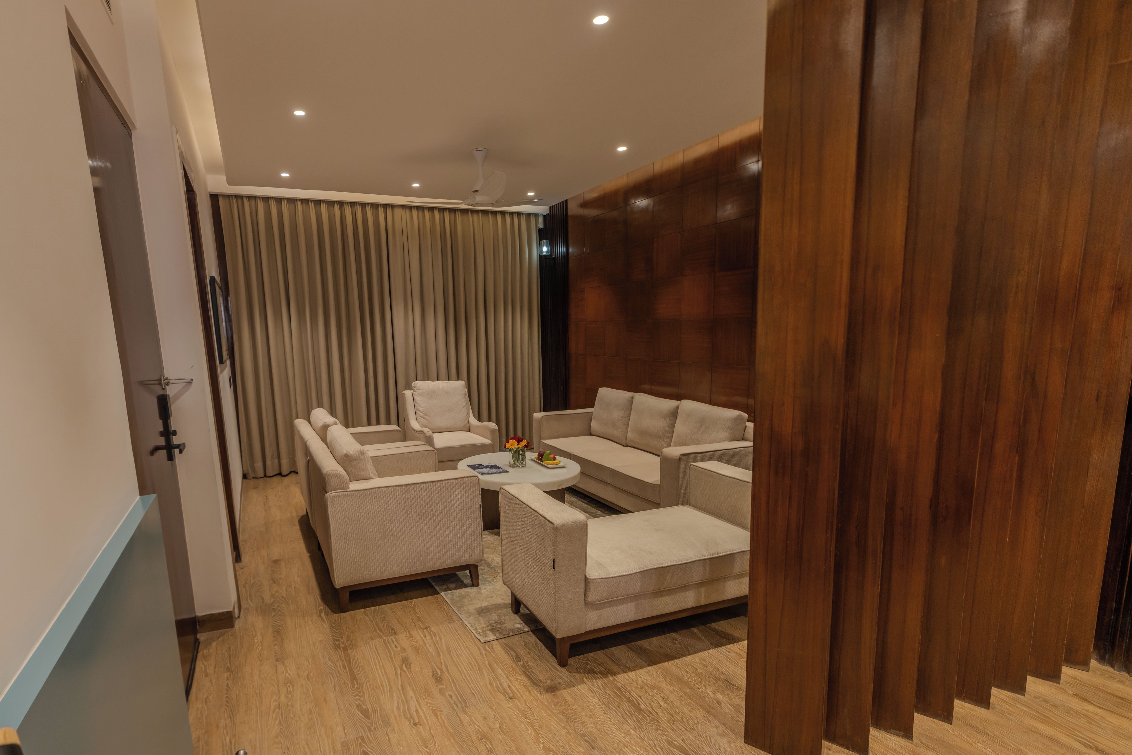 A modern living room with a sofa set, a coffee table, and a dining table.
