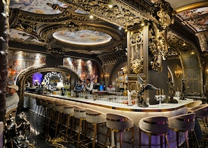 An opulent bar area with ornate gold detailing, a marble countertop, and plush bar stools. - Arte Mont Kiara by Kuala Lumpur (Kuala Lumpur)