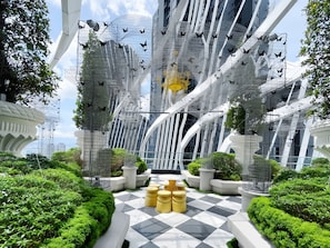 A modern building with a checkered floor, surrounded by greenery and white columns. - Arte Mont Kiara by Kuala Lumpur (Kuala Lumpur)