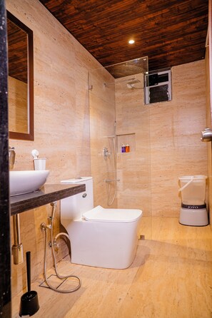 A bathroom with a bathtub, toilet, and shower.