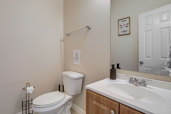 A bathroom with a toilet, sink, and mirror. - 3 Mi to Dtwn! Houston Family Haven w/ Private Yard (Houston)