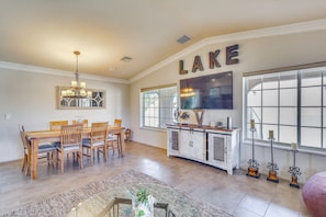 A spacious dining area with a wooden table and chairs, a chandelier, and a large window with a view. - 2 Mi to Windsor Boat Launch! Lake-View Escape (Lake Havasu City)