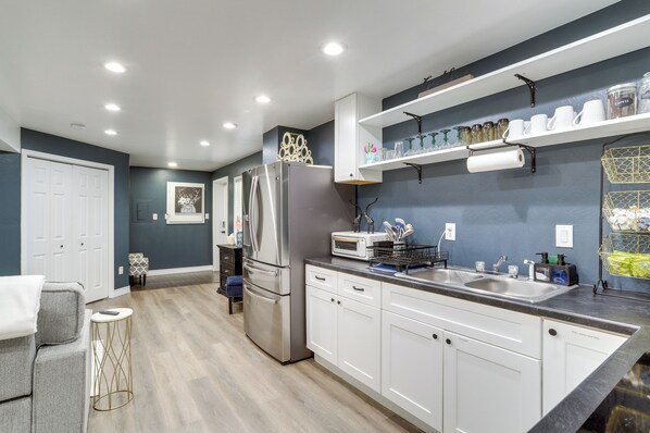 A modern kitchen with white cabinets, stainless steel appliances, and a built-in oven. - 5 Mi to Barr Lake! Suburban Family Retreat (Brighton)
