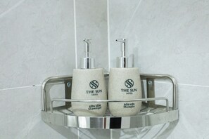 Two showerheads with pumps, labeled 'The Sun Hotel,' and a metal shelf with a handle. - The Sun Hotel - Ninh Bình (Ninh Binh)