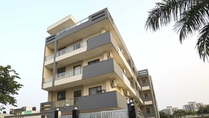 A multi-story residential building with balconies, a gated entrance, and a modern architectural design. - The Vertigo (Noida)