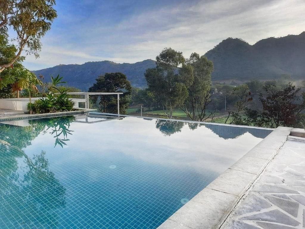 An infinity pool with a clear view of mountains in the background.