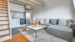 A modern living space with a kitchen, a dining area, and a sofa set. - 3P duplex on the outskirts of Paris (Le Kremlin-Bicêtre)