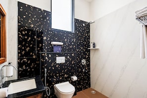 A bathroom with a toilet, sink, shower, and a towel rack. - Hiara Crystal 5BHK Villa with Pool (Udaipur)
