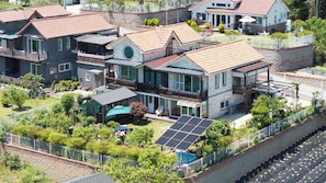 A residential area with multiple houses, a swimming pool, and solar panels.
