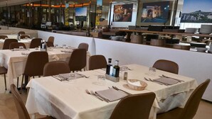 A restaurant with multiple tables, chairs, and a counter area. - Hotel Miralaghi Family & Sport (Chianciano Terme)