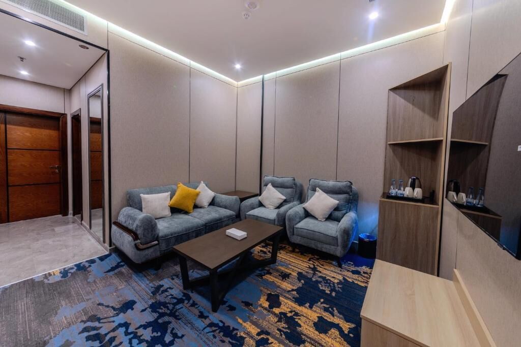 A modern living room with a sofa set, a coffee table, and a TV stand.