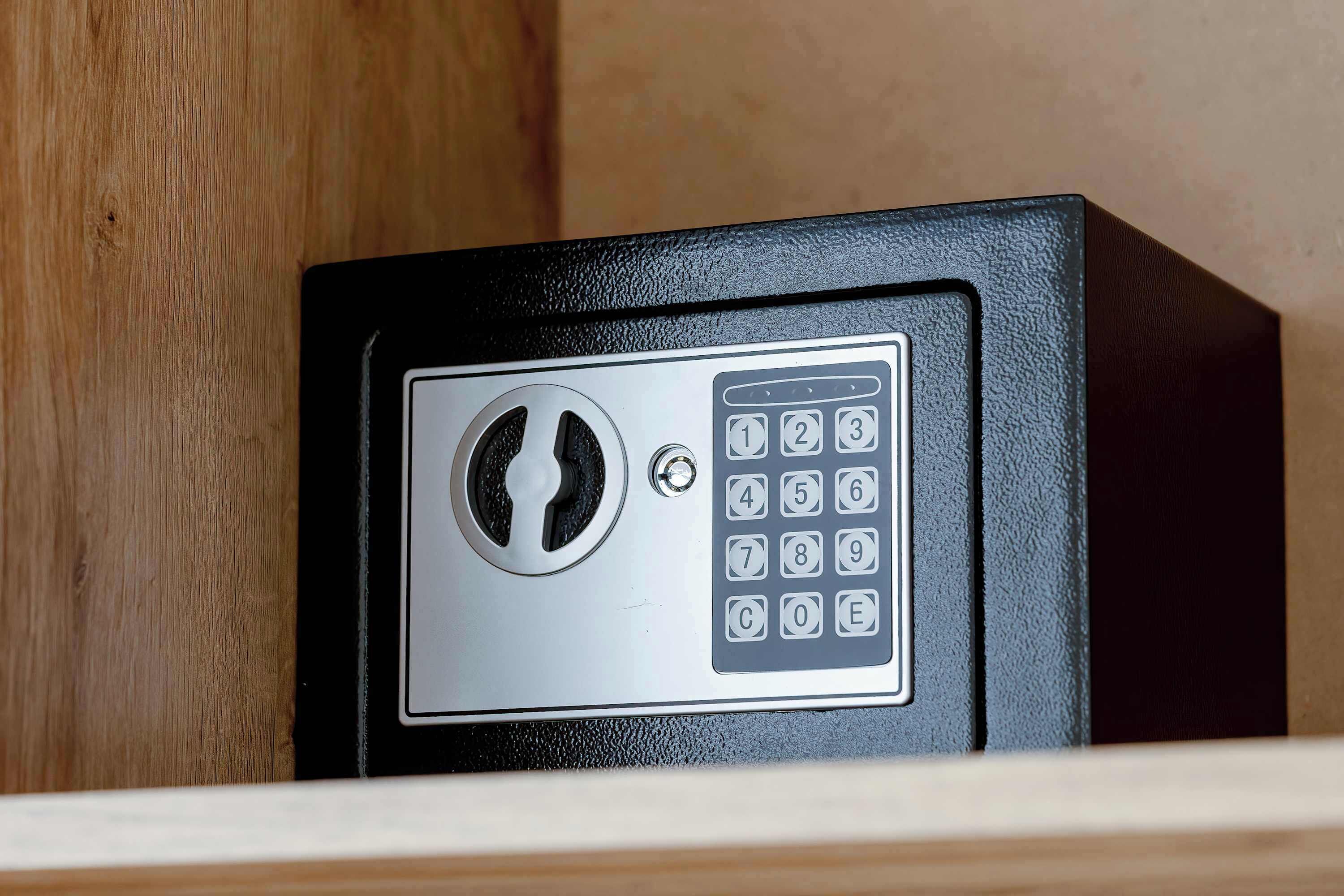 A safe with a keypad and a keyhole.