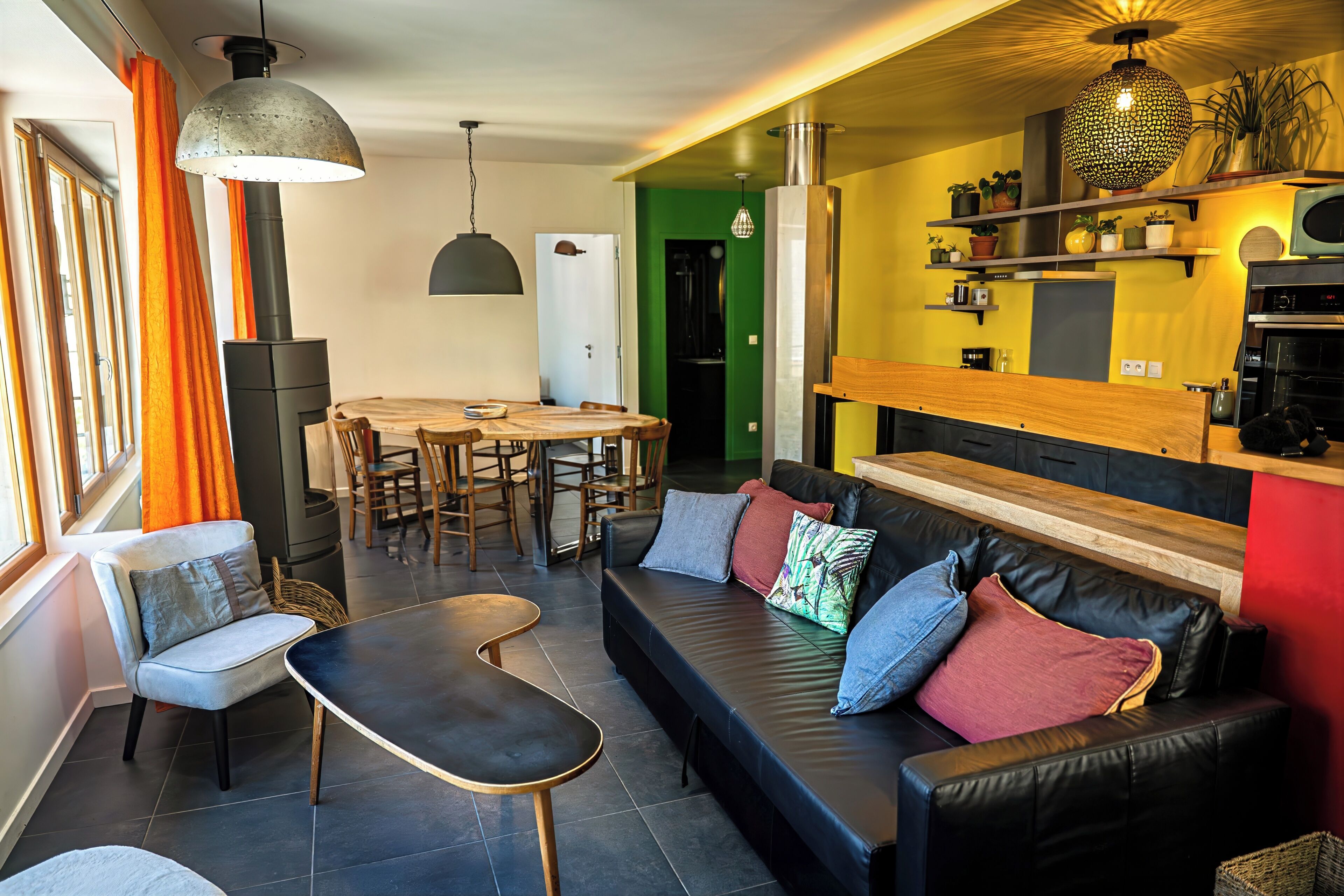 A modern living room with a sofa, chairs, a dining table, and a kitchen area.. Gîte 5 pers Chartreuse: balcony, mountain view, stove, 2 bedrooms, 2 bathrooms | Le Duc