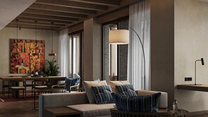 A modern living room with a sofa, striped pillows, a dining area with chairs, and a large abstract painting on the wall. - Hotel Indigo Bukhara by IHG (Bukhara)