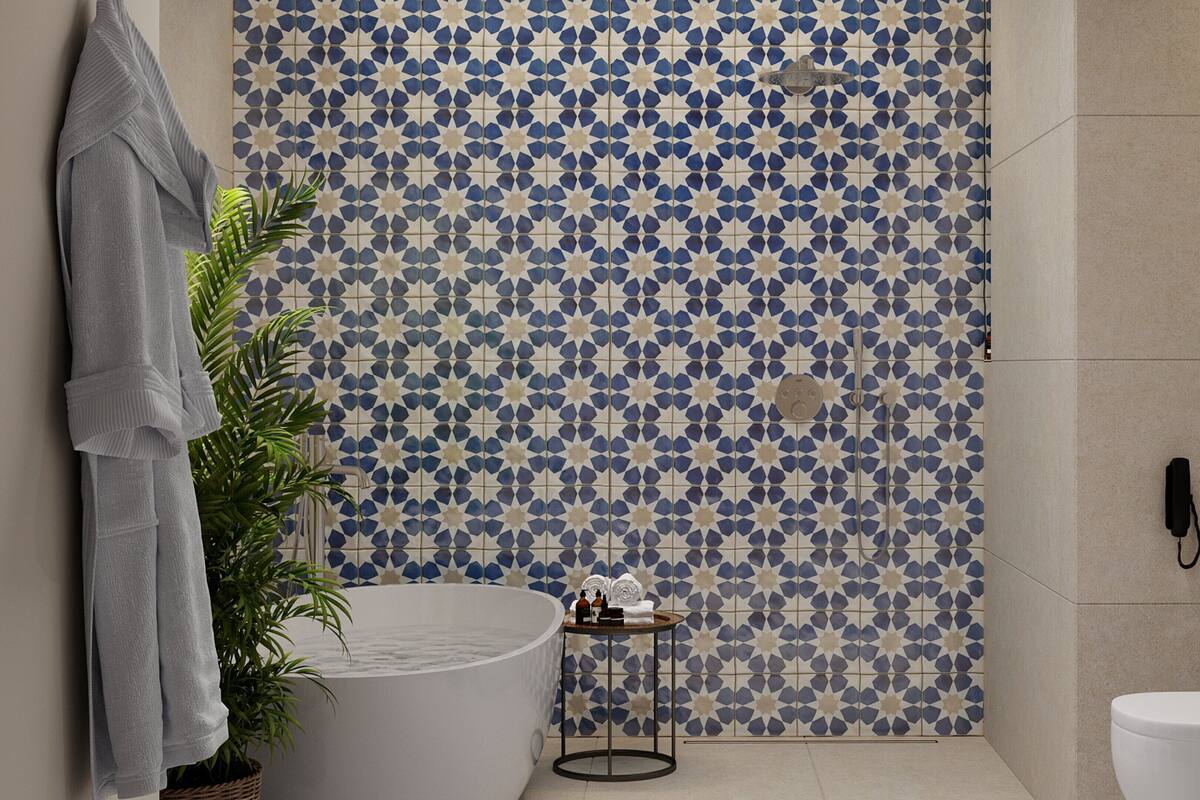 A bathroom with a patterned tile wall, a bathtub, a towel rack, a plant, and a toilet.