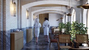 Un espacio de spa con paredes de ladrillo, armarios de madera y muebles de mimbre.