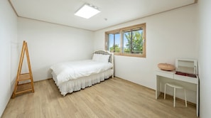 A bedroom with a bed, a desk, a chair, a ladder, and a window. - Ganghwa Sunset Hill Private Pension (Incheon)