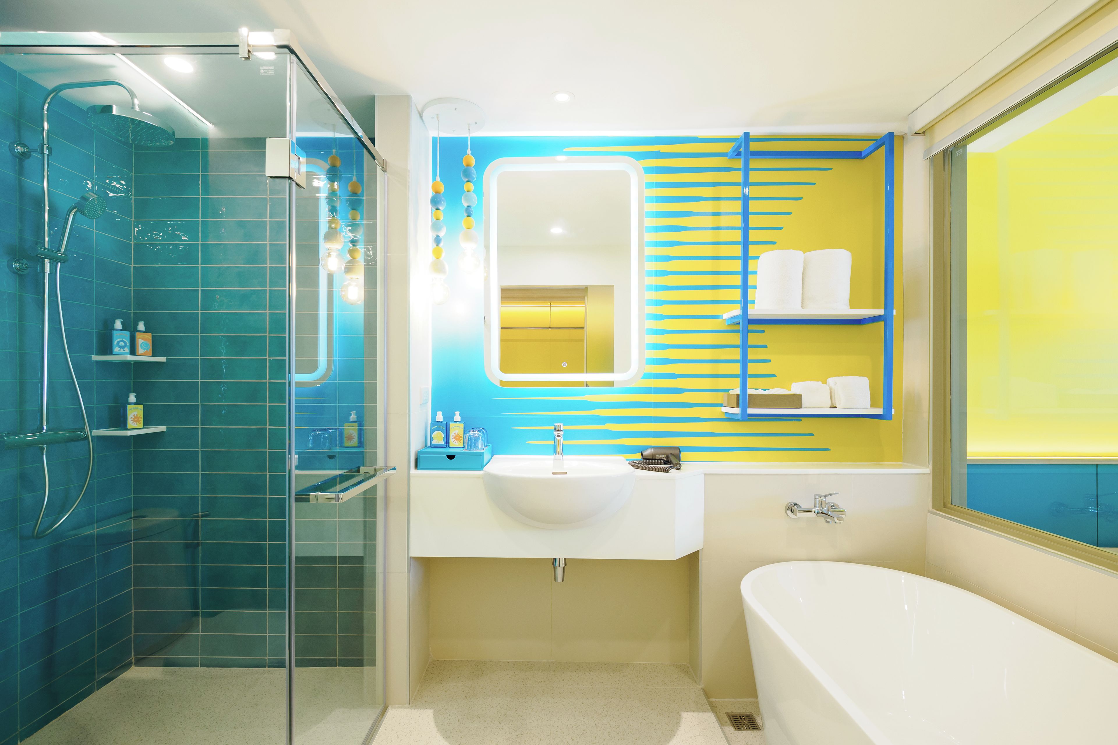 A modern bathroom with a glass-enclosed shower, a white sink, and a bathtub.