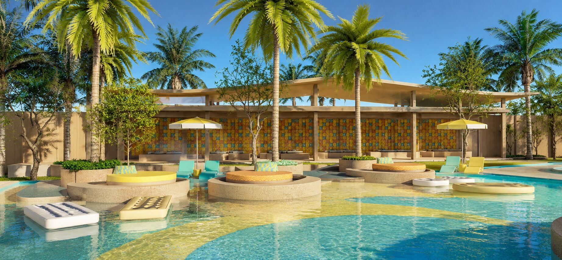 A pool area with lounge chairs, palm trees, and a building with patterned walls.