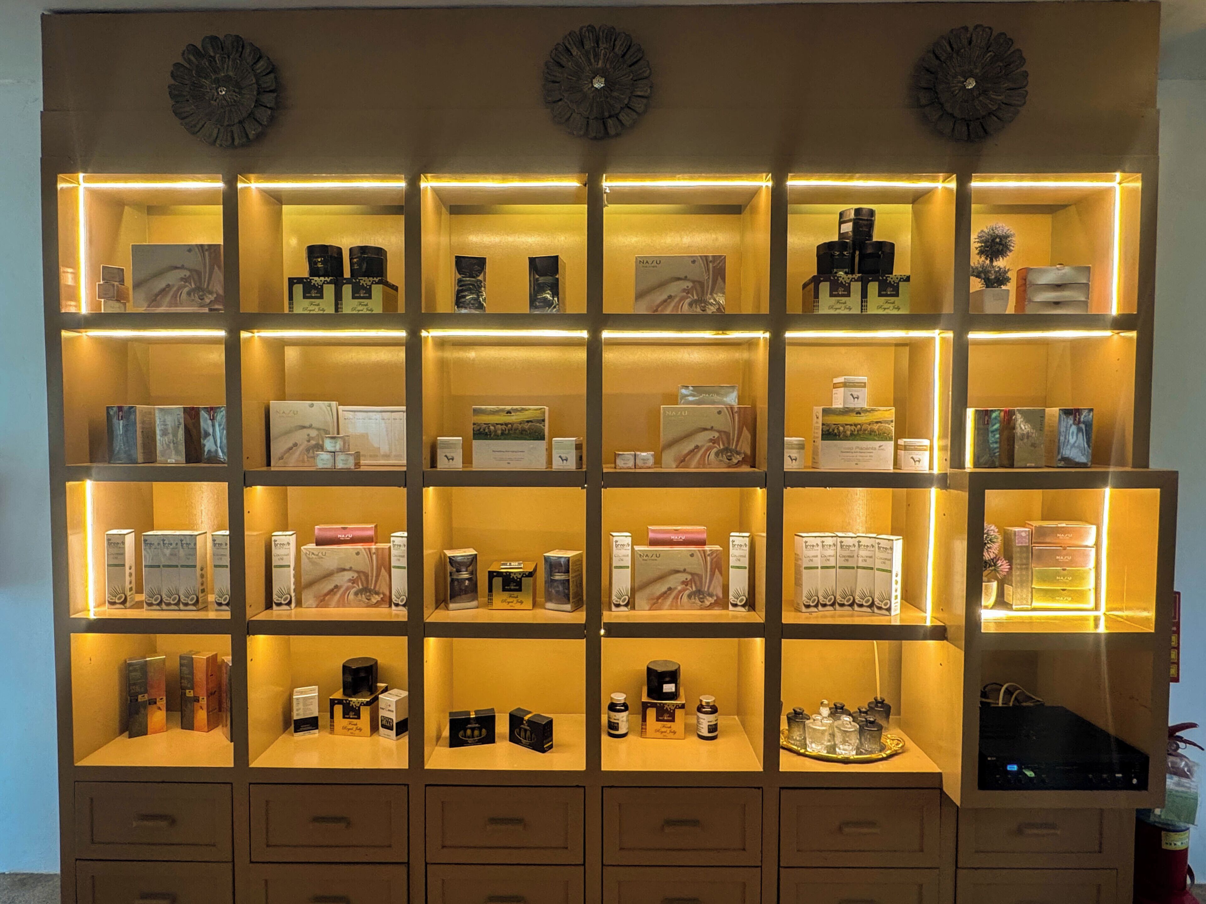 A well-lit display of various products in a multi-tiered shelving unit.