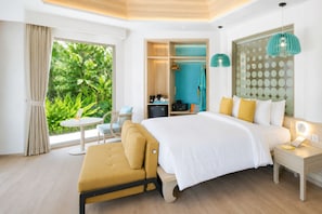 A bedroom with a bed, bedside table, and a view of greenery outside.
