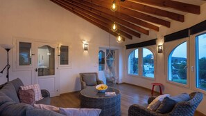 A spacious living area with a high ceiling, large windows, and a view of the outside. - Villa SAO PAULO by Abahana Villas (Moraira)