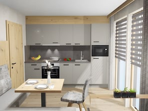 Eine moderne Küche mit Essbereich, Holzschränken, einer Mikrowelle und einem für zwei Personen gedecktem Tisch.