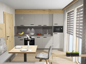 Eine moderne Küche mit Essbereich, Holzschränken, einer Mikrowelle und einem für zwei Personen gedecktem Tisch.